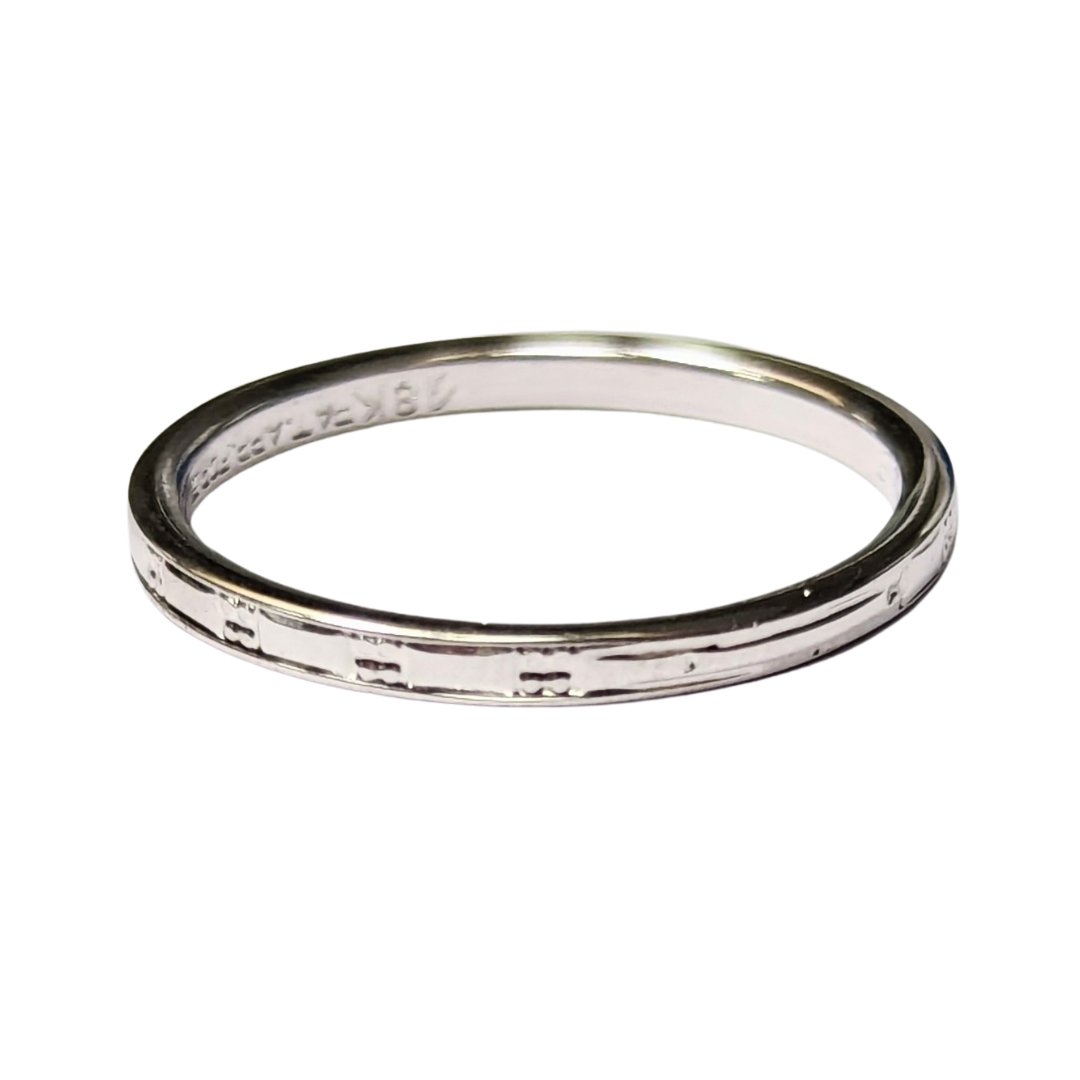 2mm 18k white gold band, size 5.5, featuring a delicate engraved pattern and a polished metallic finish.