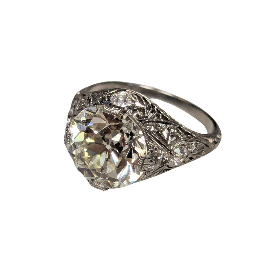 Art Deco platinum ring featuring a 5.01-carat Old European cut diamond with intricate filigree metalwork.