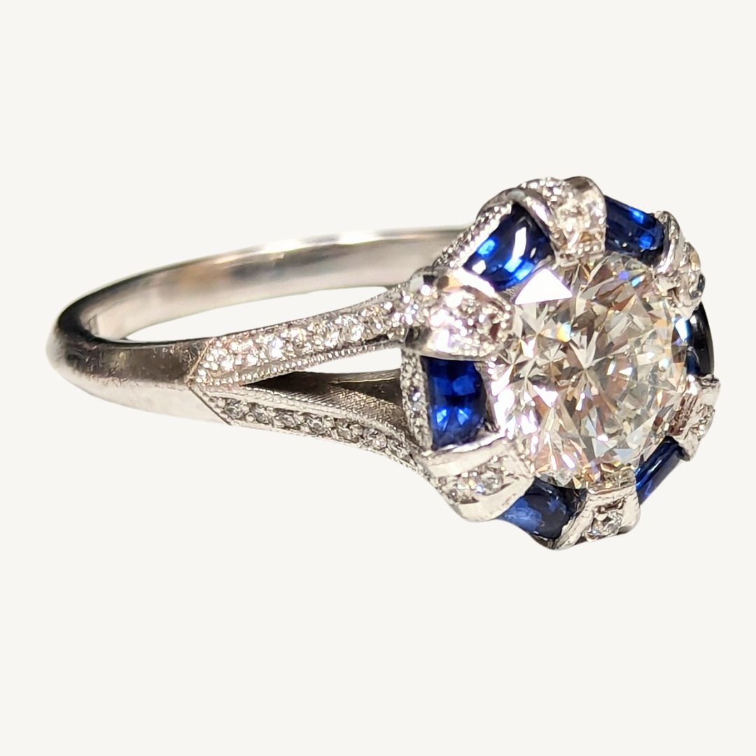 Tacori 18k white gold Art Deco ring featuring a round diamond center, blue sapphire cabochons, and diamond accents.