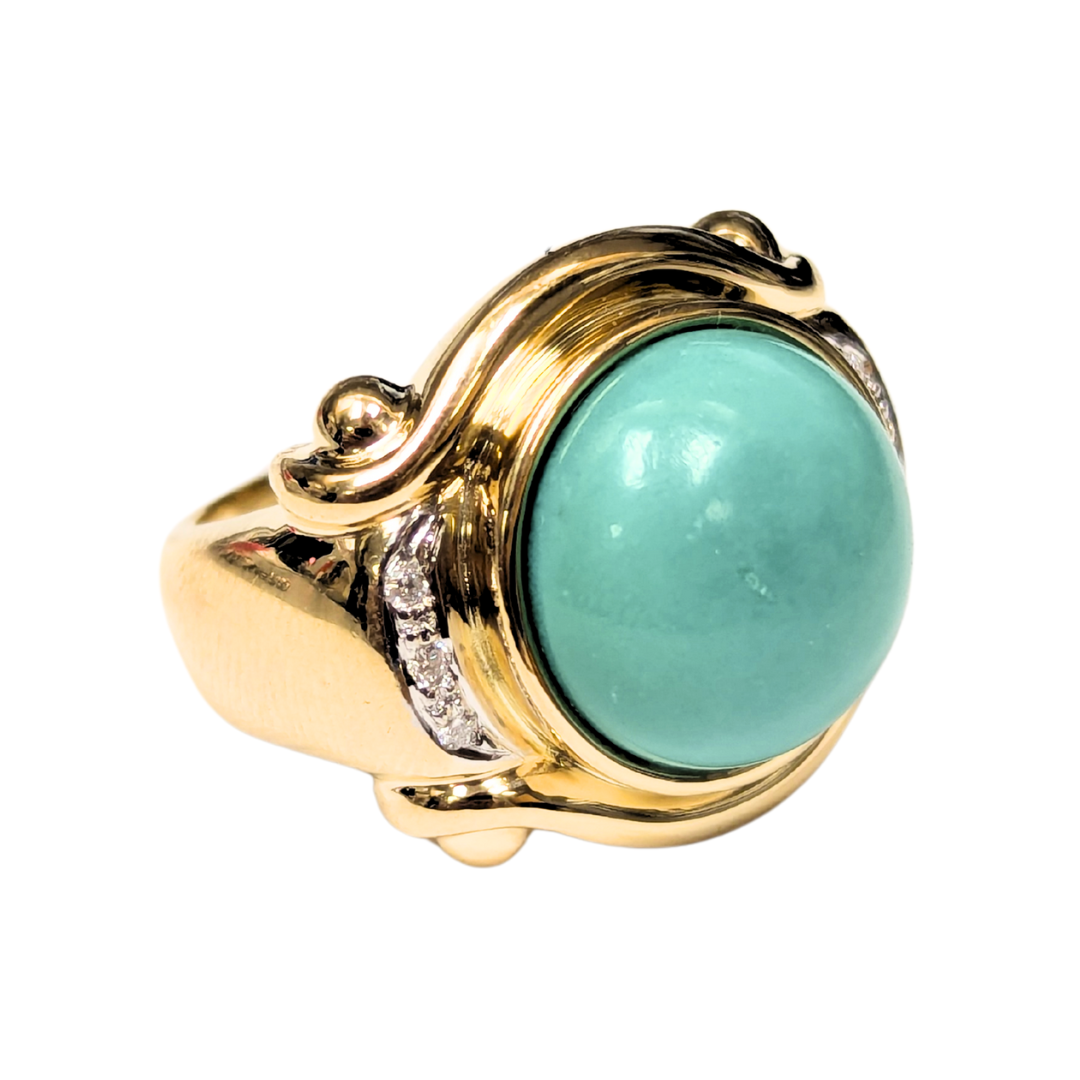 Chunky 18k yellow gold ring featuring a 13mm round turquoise cabochon and sparkling diamond accents.