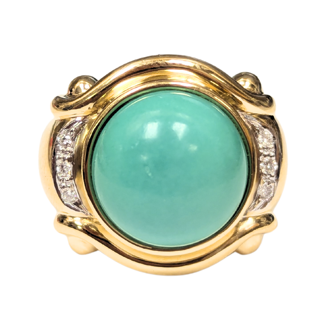 Chunky 18k yellow gold ring featuring a 13mm round turquoise cabochon accented by six brilliant-cut diamonds.