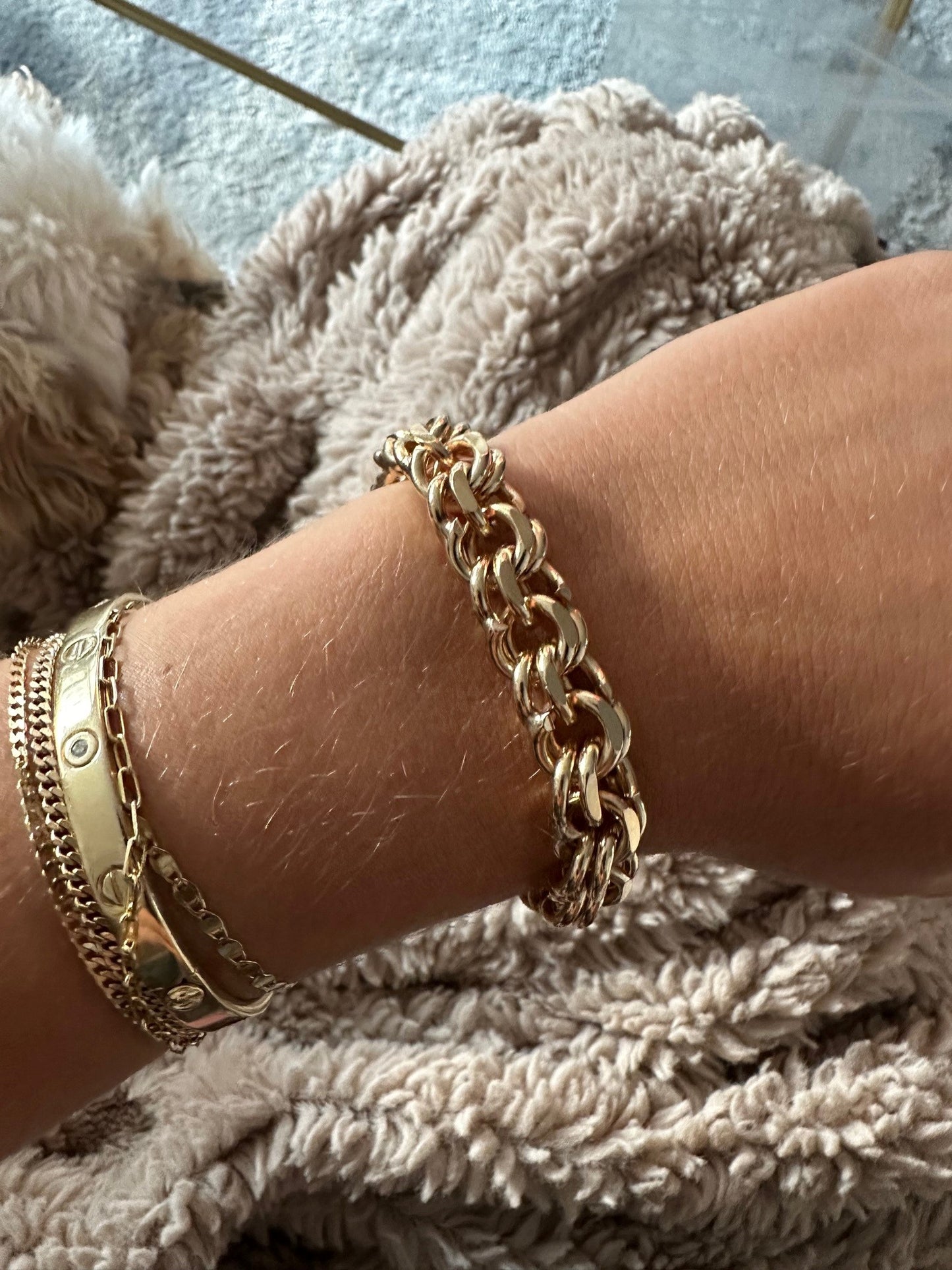 14k yellow gold double link bracelet, 7 inches long, worn on a wrist with stacked gold bangles.