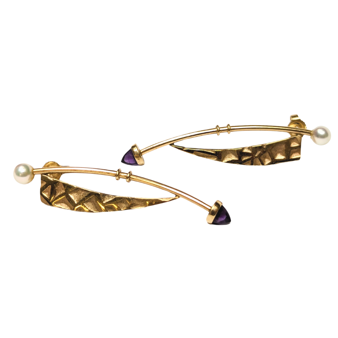Modernist 14k yellow gold drop earrings featuring textured gold bars, cultured pearls, and purple bullet-shaped amethysts.