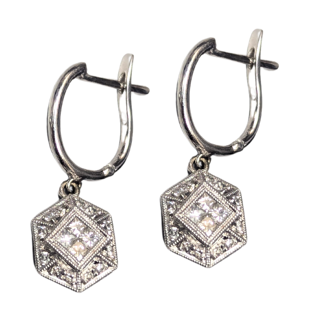 18k white gold filigree dangle earrings featuring princess and round cut diamond accents in a geometric hexagon design.