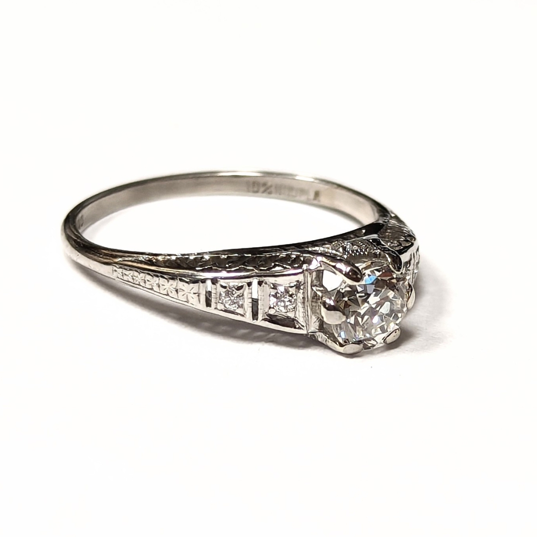 Platinum engagement ring with a 0.43ct Old European cut diamond and intricate filigree detailing.