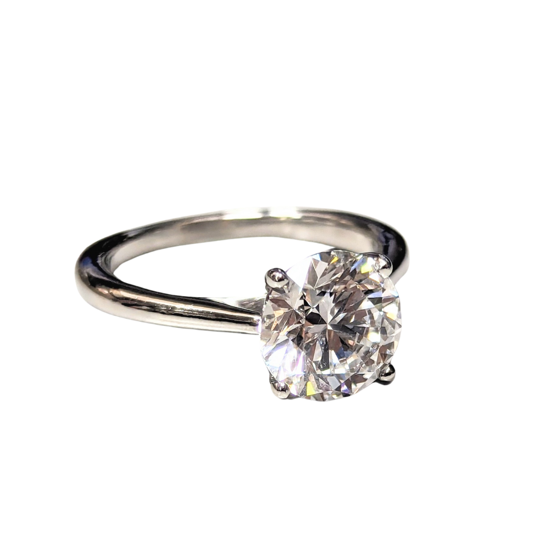 2.31 carat round brilliant cut diamond solitaire engagement ring set in polished platinum on a white background.