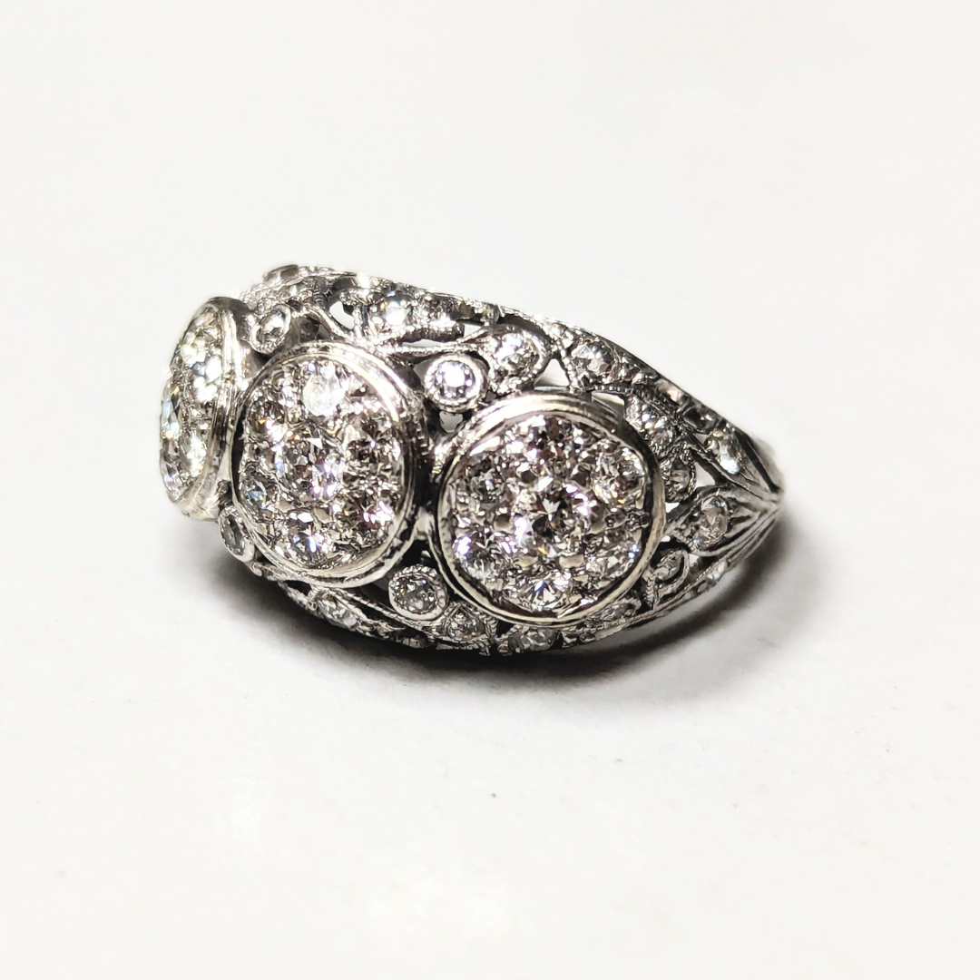 Platinum Art Deco filigree cluster ring featuring 49 sparkling diamonds set in intricate metalwork.