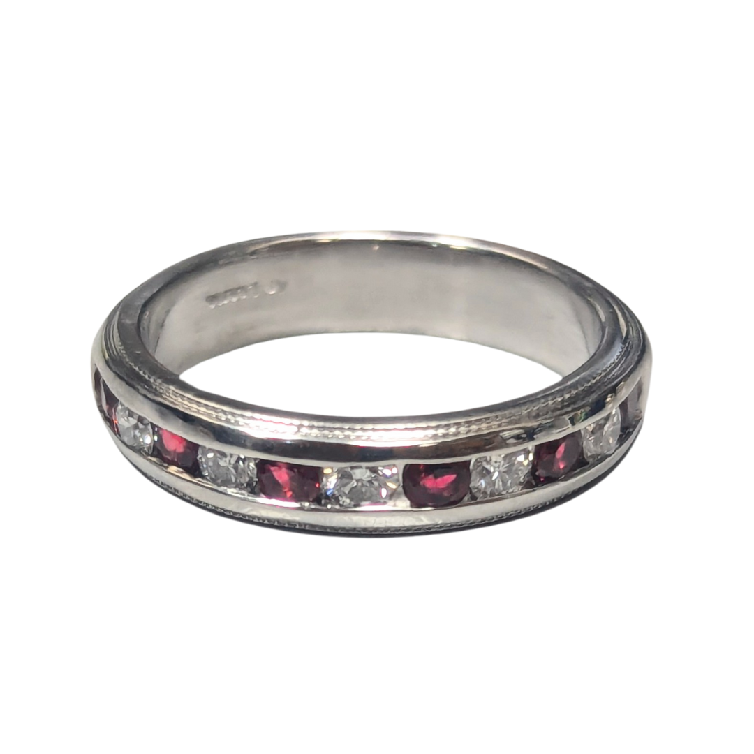 Platinum channel-set band featuring alternating round brilliant diamonds and vibrant red rubies.