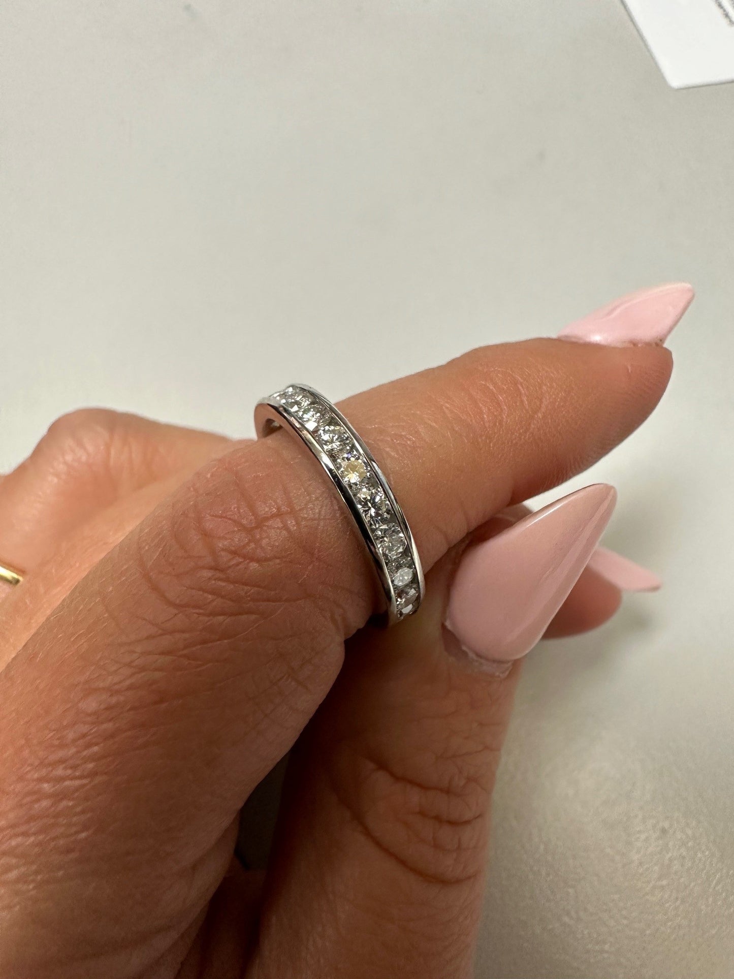 Platinum eternity band featuring 23 channel-set round brilliant diamonds on a 3.5mm band.