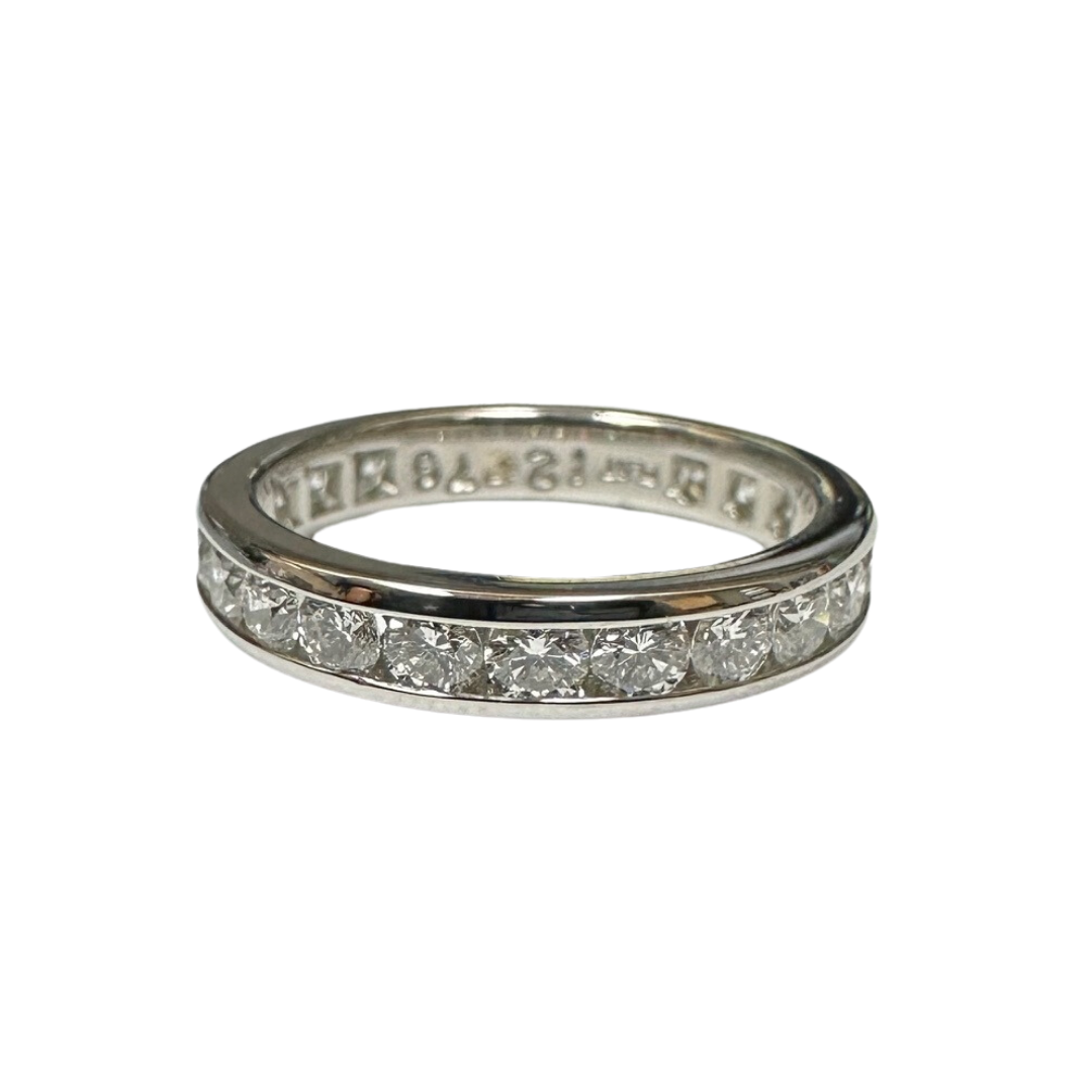 Platinum eternity band featuring 23 channel-set round brilliant diamonds in a 3.5mm wide polished metal setting.