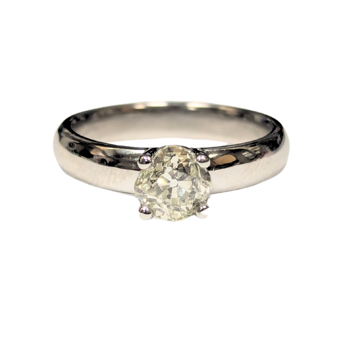 Platinum engagement ring featuring a 0.90 carat old mine cut diamond center stone on a polished silver band.