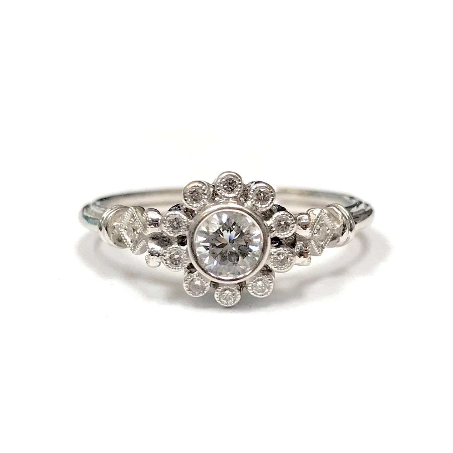 Beverley K 18k white gold flower ring featuring a round brilliant diamond center and sparkling diamond halo accents.