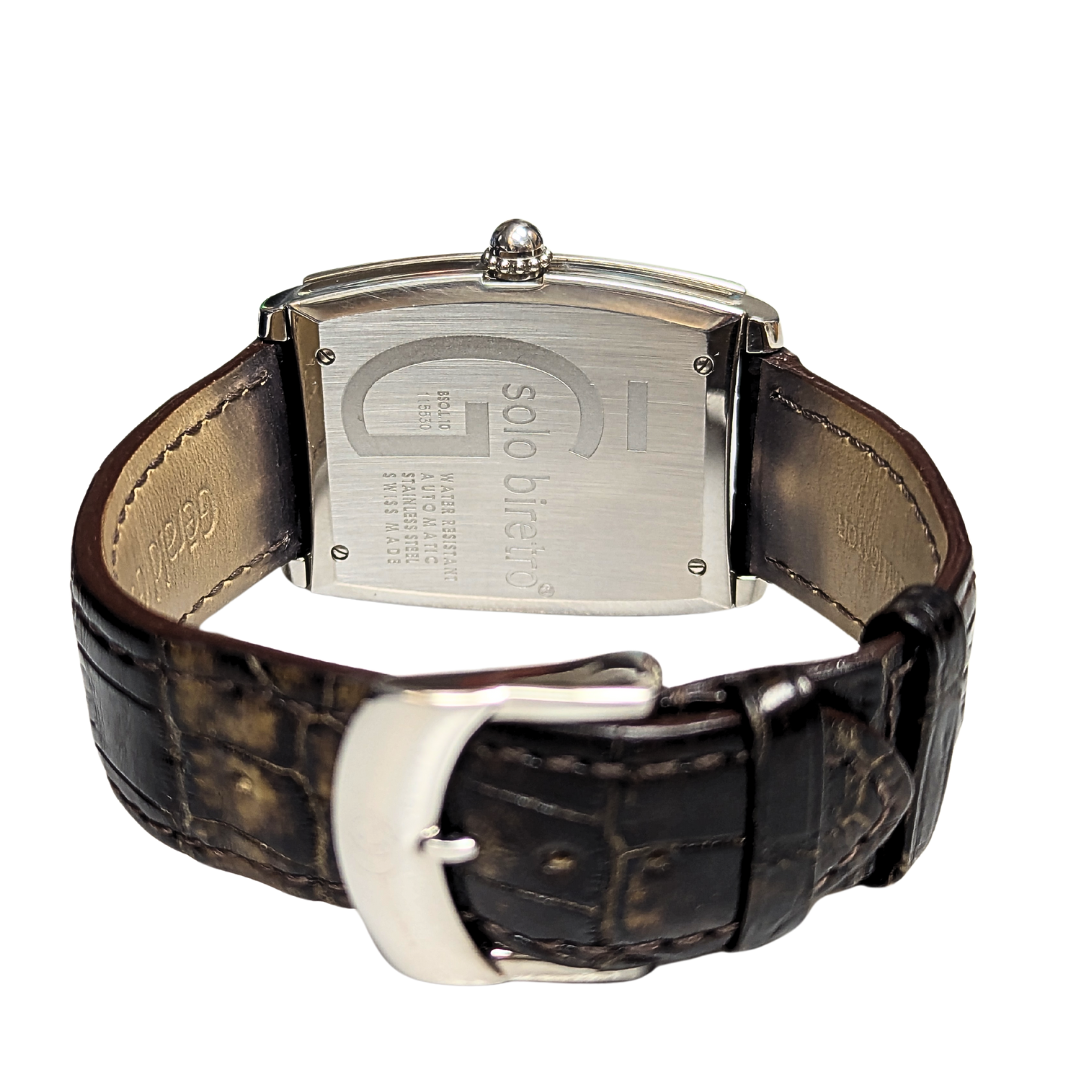 Case back of a stainless steel Gerald Genta Solo Biretro watch with a brown alligator leather strap and steel buckle.