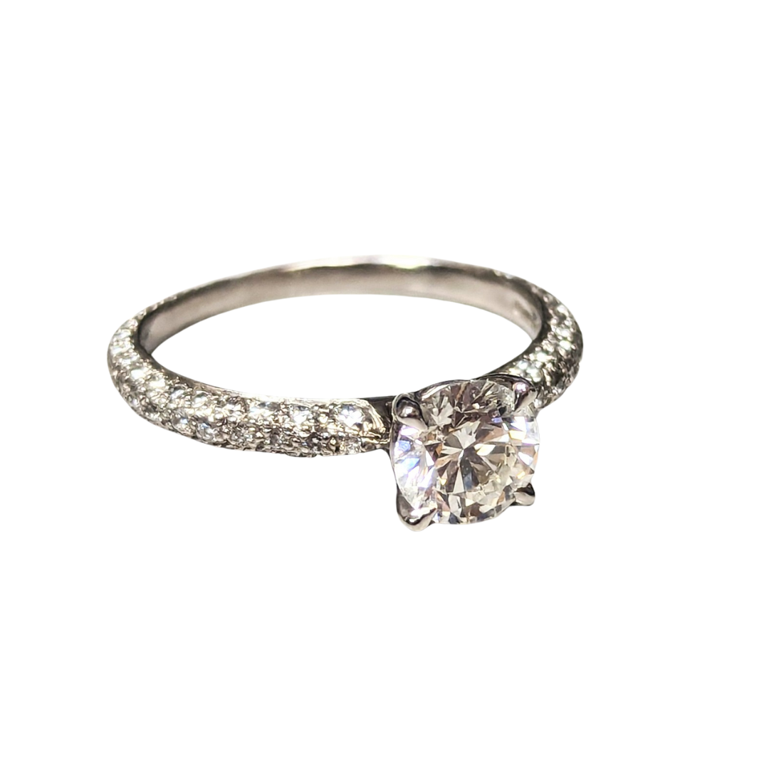 Renaissance platinum engagement ring with a round brilliant center diamond and diamond-encrusted band.