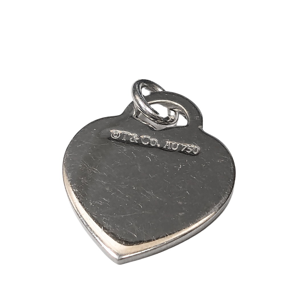 Back of Tiffany & Co. 18k white gold heart pendant with AU750 hallmark and visible surface scratches.