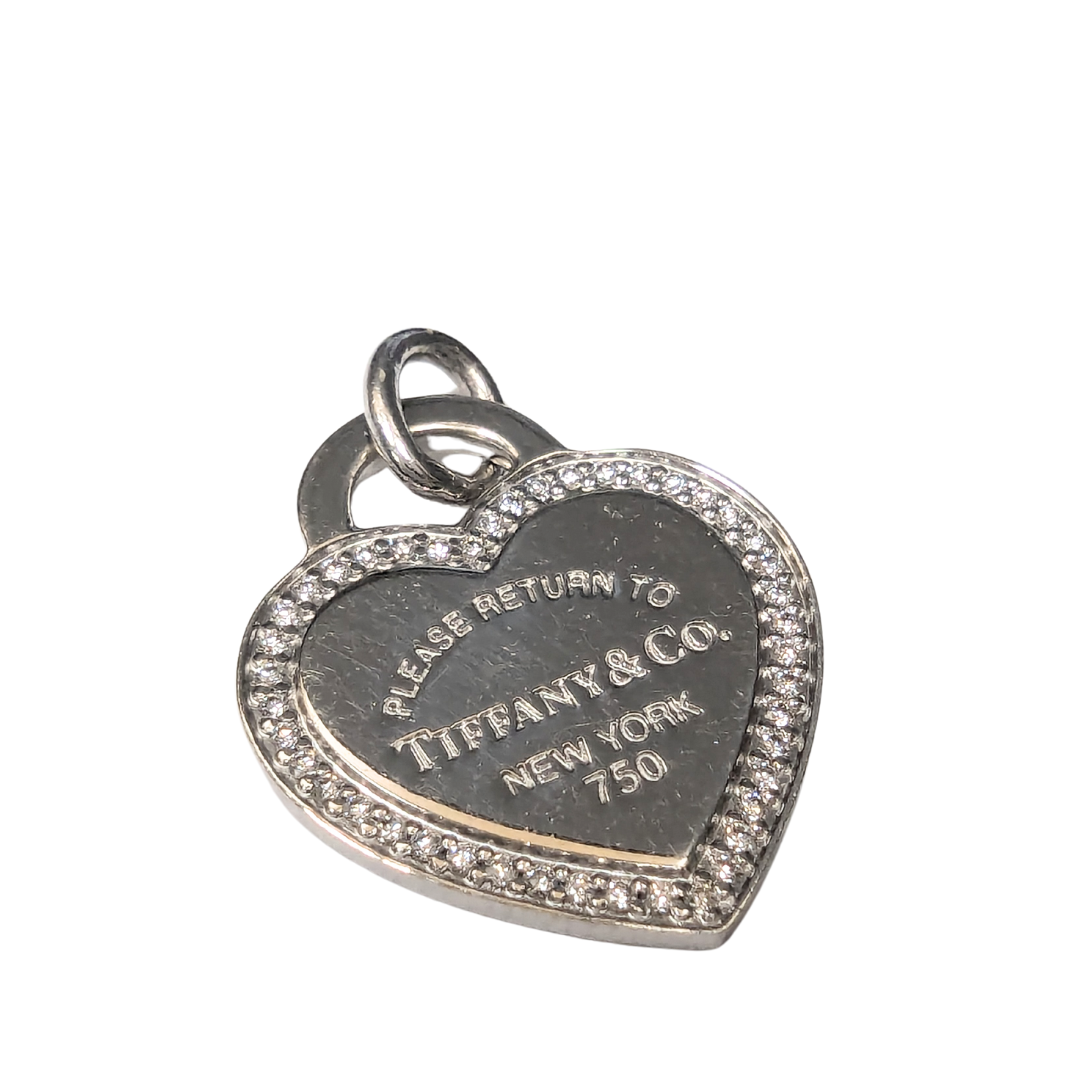 Tiffany & Co. 18k white gold heart pendant with diamond pavé border and engraved Return to Tiffany logo.