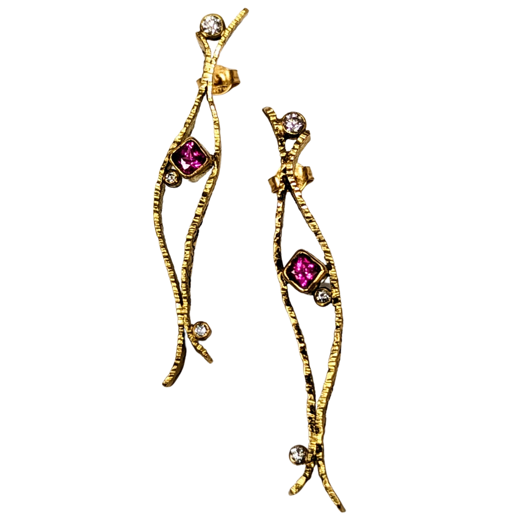 18K yellow gold drop earrings featuring cushion-cut rubies and brilliant-cut diamonds in a textured, slender design.