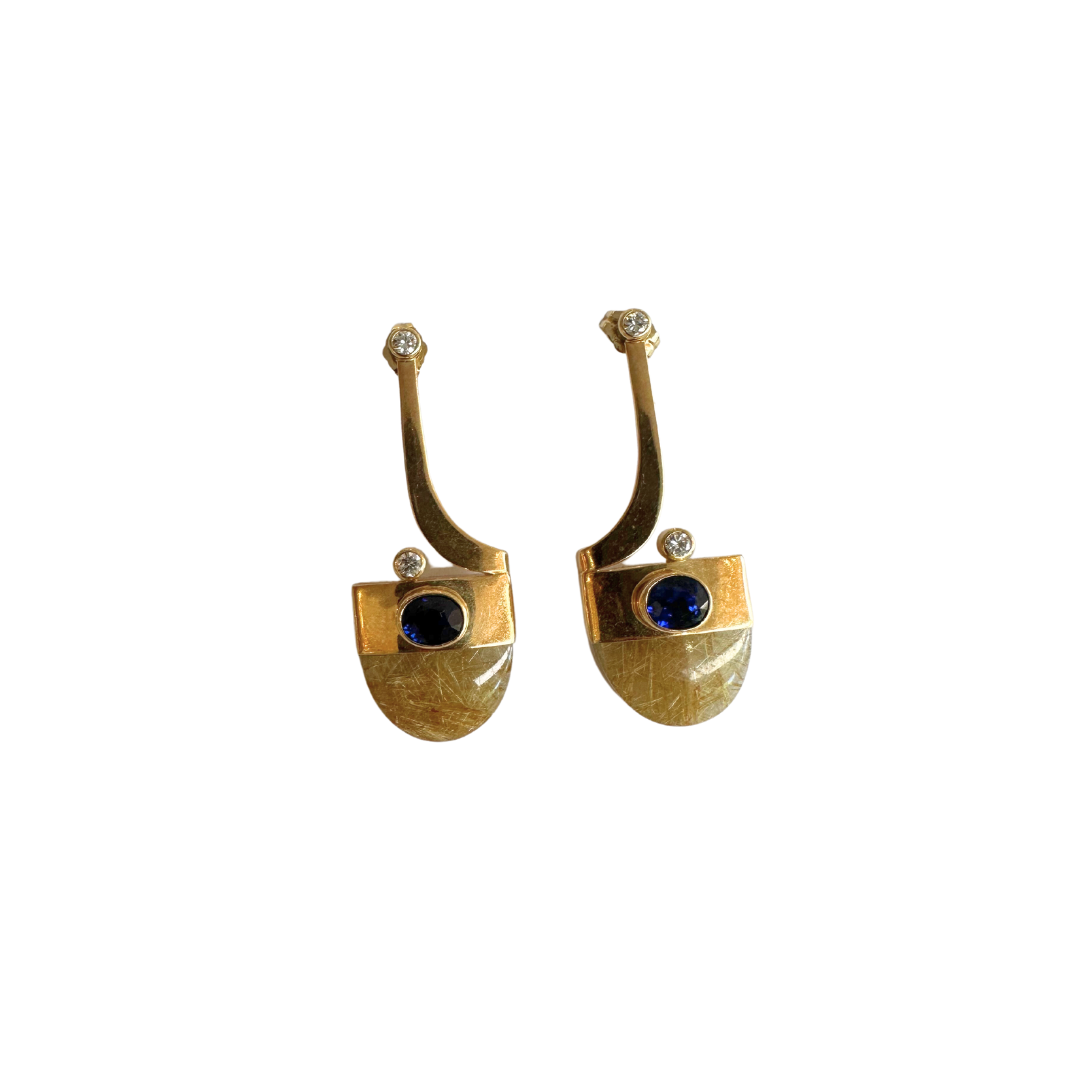 14K yellow gold drop earrings featuring rutilated quartz, oval blue sapphires, and brilliant cut diamond accents.