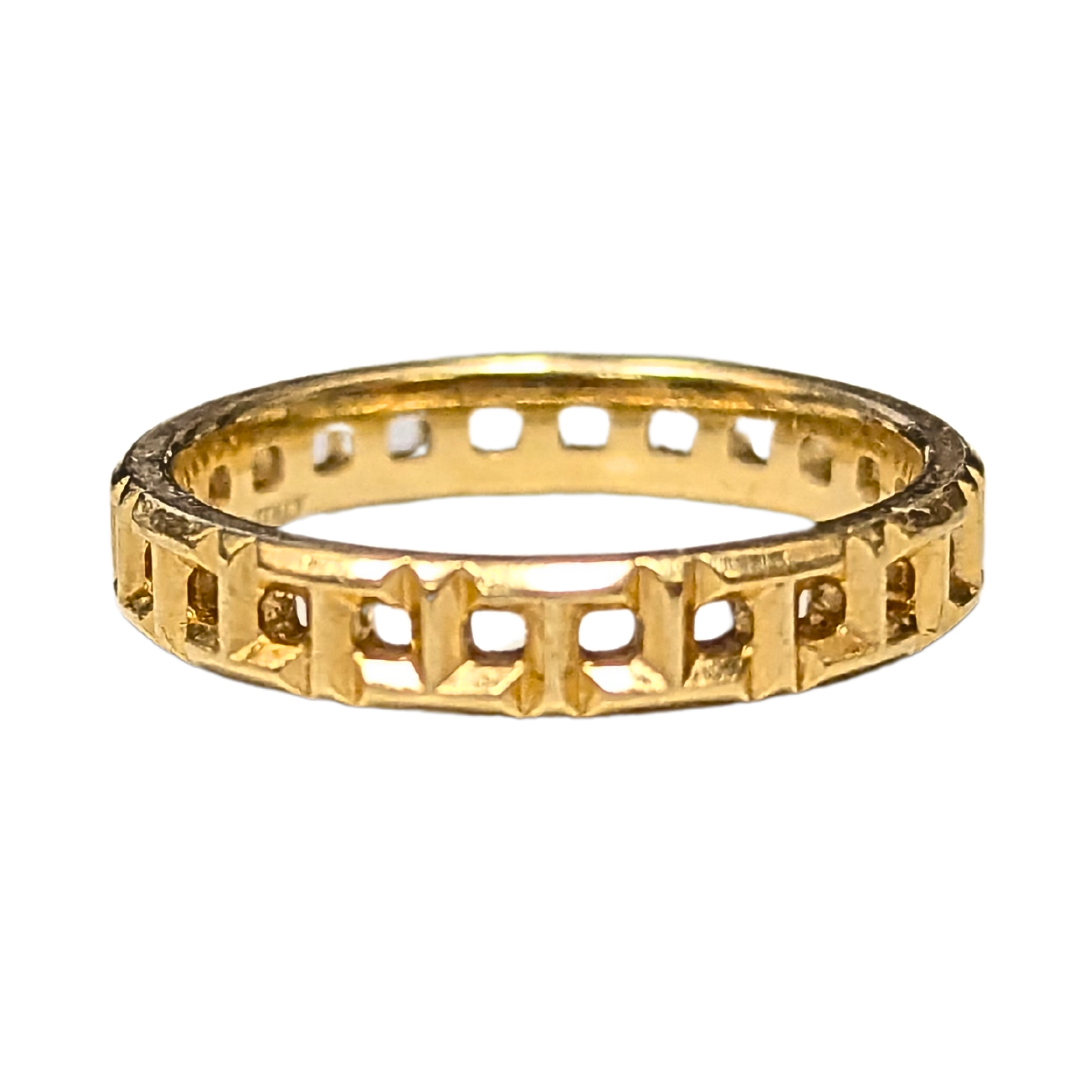 Tiffany & Co. T True band ring in 18k yellow gold featuring an interlocking T geometric design, size 6.