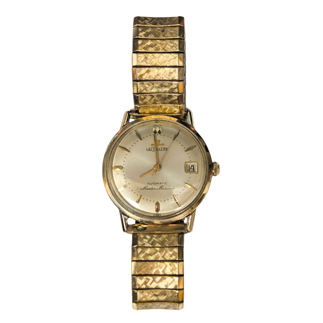 Vintage 14k gold-filled Le Coultre Master Mariner automatic watch with a textured gold-tone expandable band.