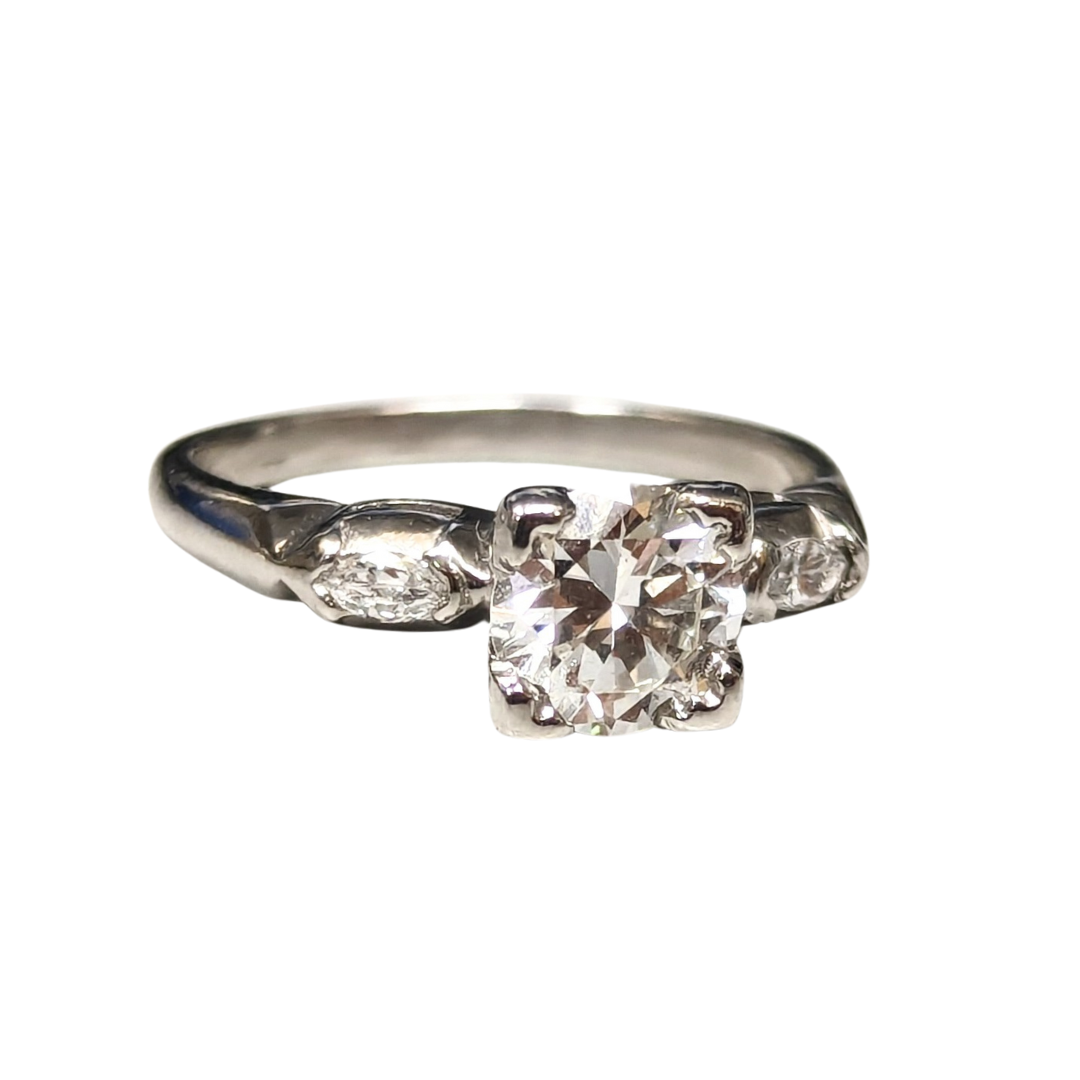 Vintage platinum three-stone ring featuring a 0.84ct European cut diamond flanked by two marquise accent diamonds.