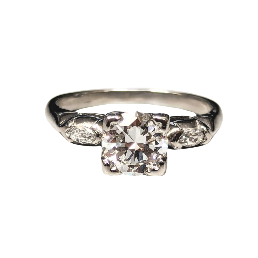 Vintage platinum three-stone ring featuring a central European cut diamond flanked by two marquise accent diamonds.
