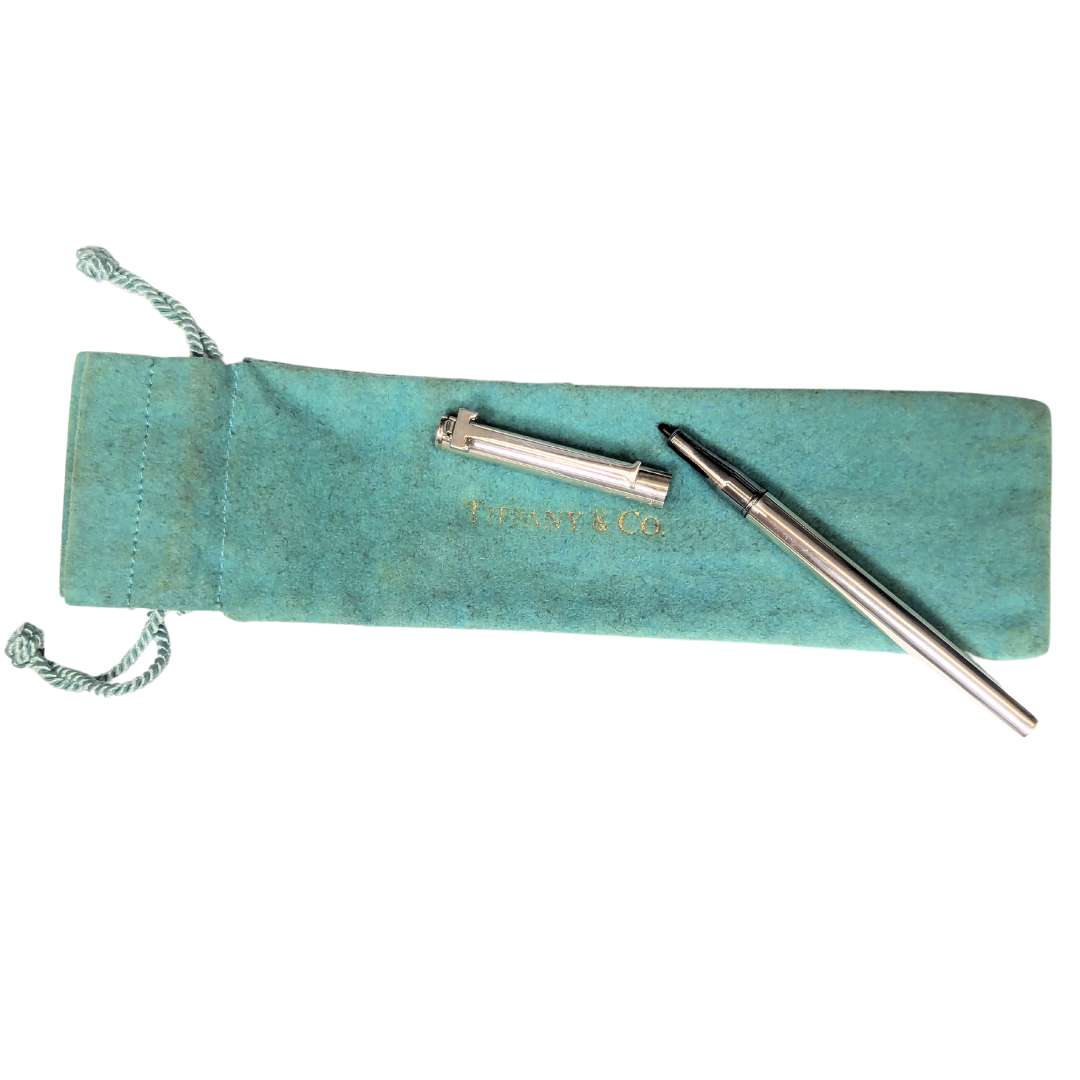 Vintage Tiffany & Co. sterling silver T-clip ballpoint pen with a signature blue fabric drawstring sleeve.